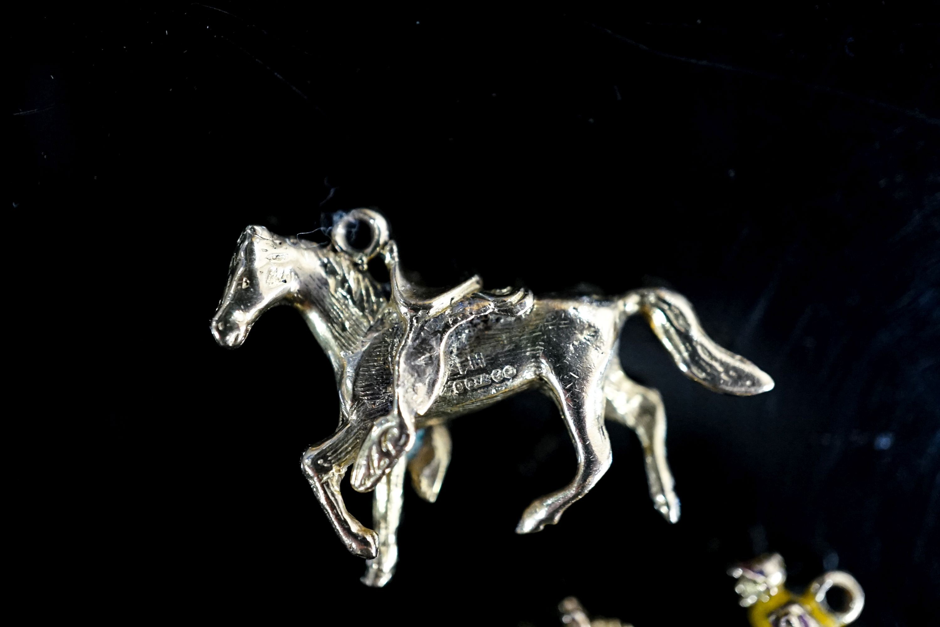 Two 9ct gold horse pendant charms including enamelled horse and jockey(a.f.), 33mm, gross 14.7 grams.